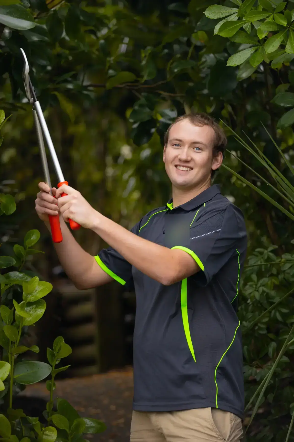 Eric Missen, owner of All Incredible Property Services, trimming a hedge