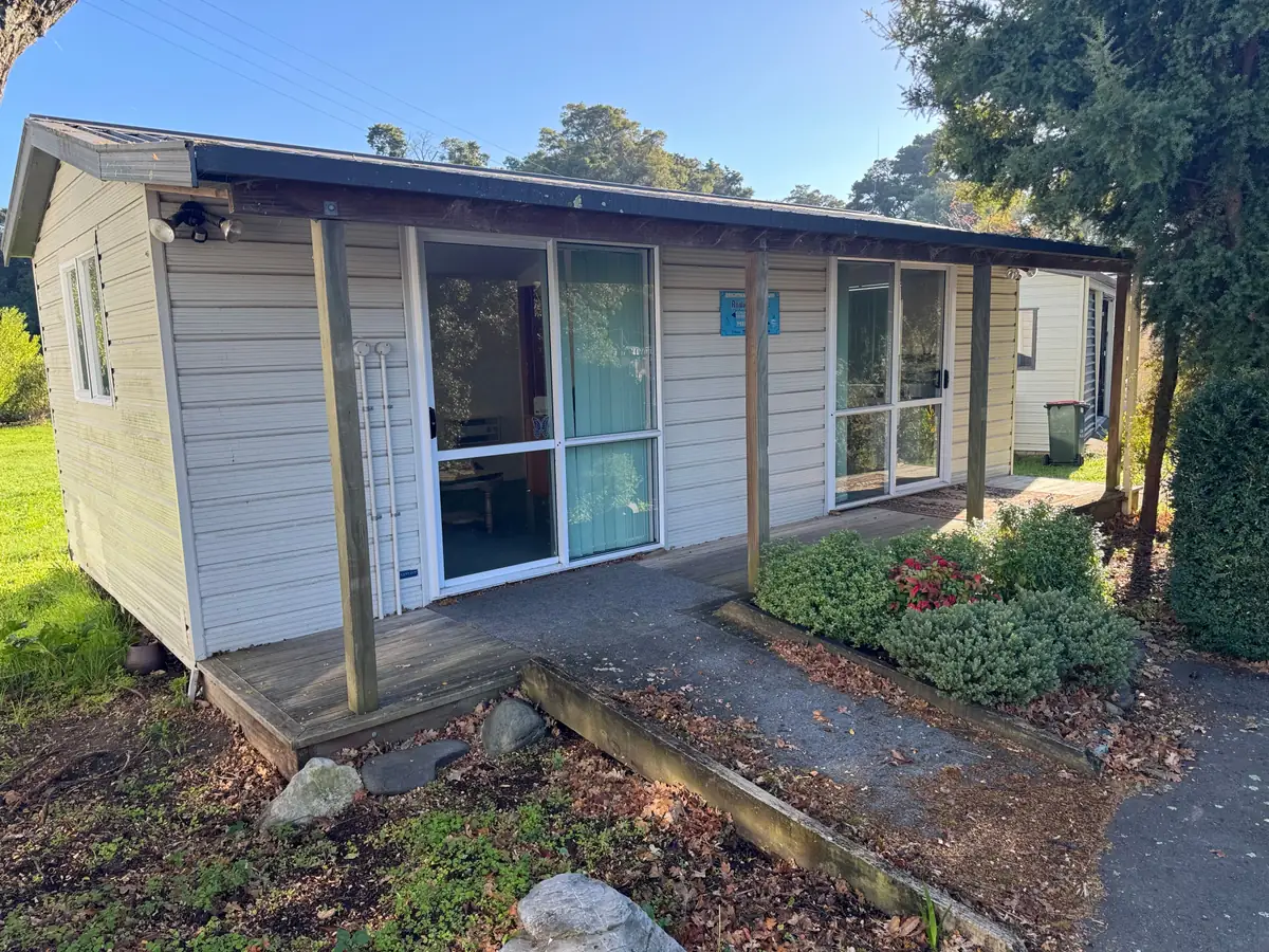 A cabin with washed cladding and a cleaned concrete path