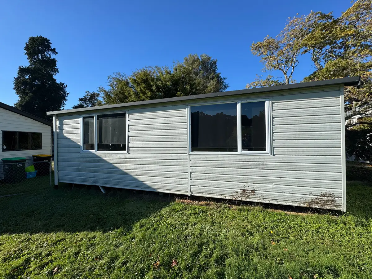 A weatherboard building with clean white cladding after an exterior wash