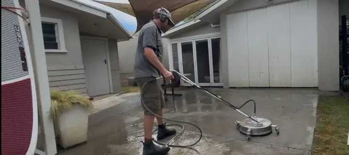 Eric water blasting a concrete patio in Nelson with a rotary surface cleaner