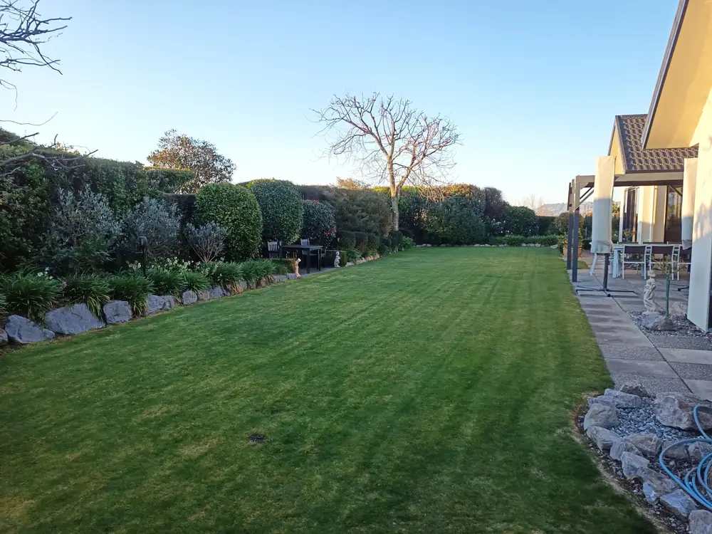 A long hedge-lined lawn freshly mown