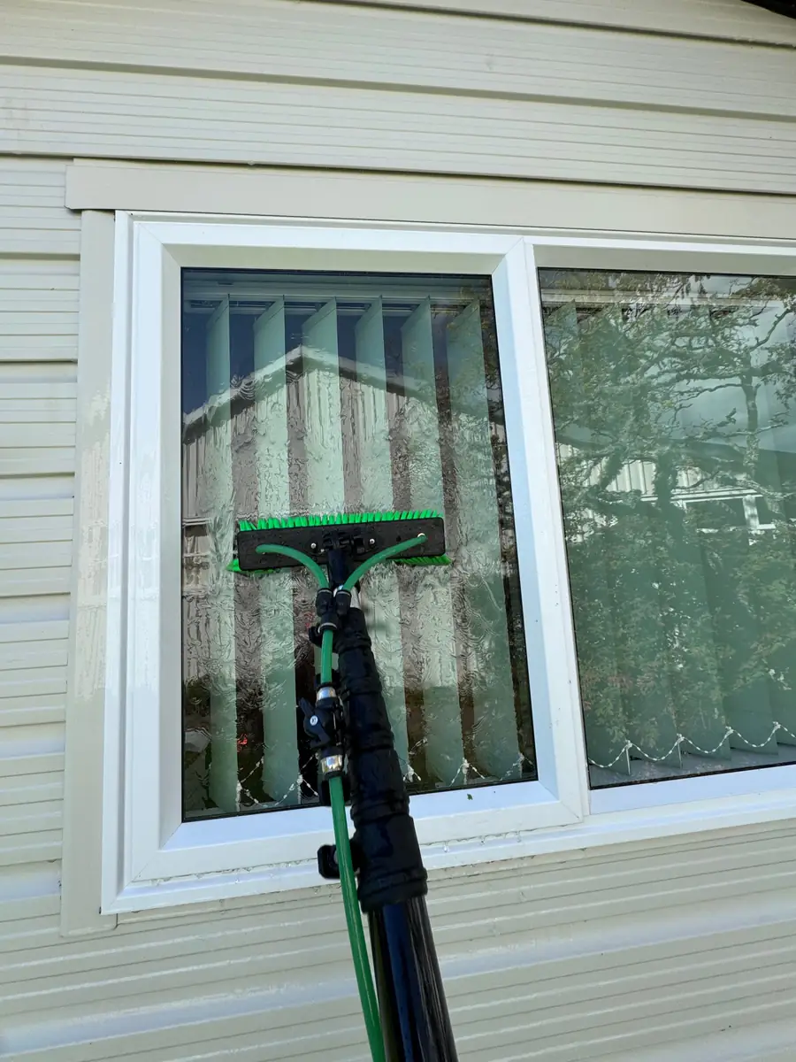 Pure water window cleaning pole on a window in Nelson